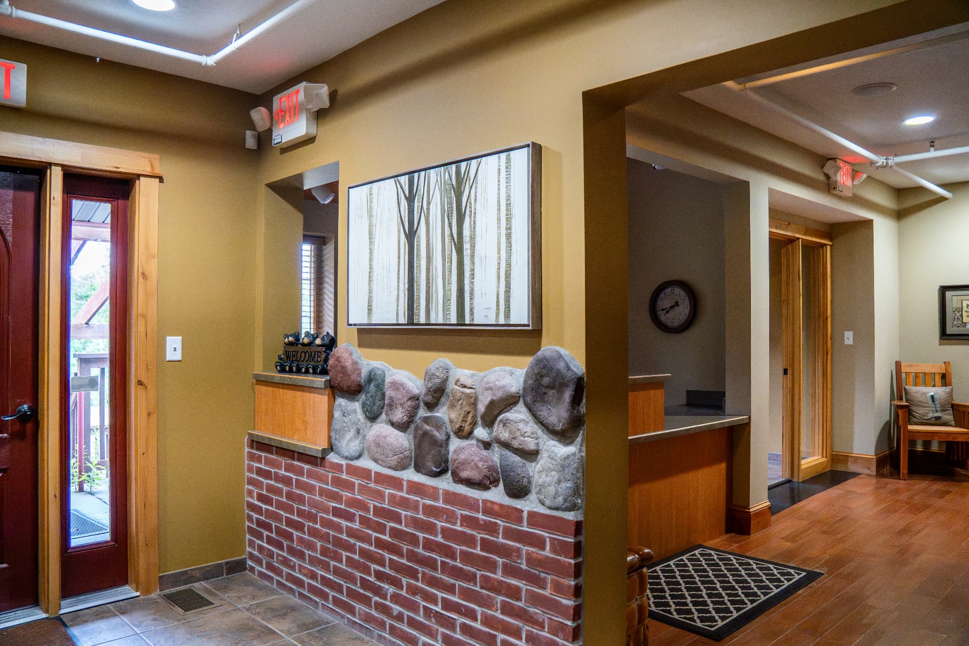 Entry hall with stone half-walls and timber trim